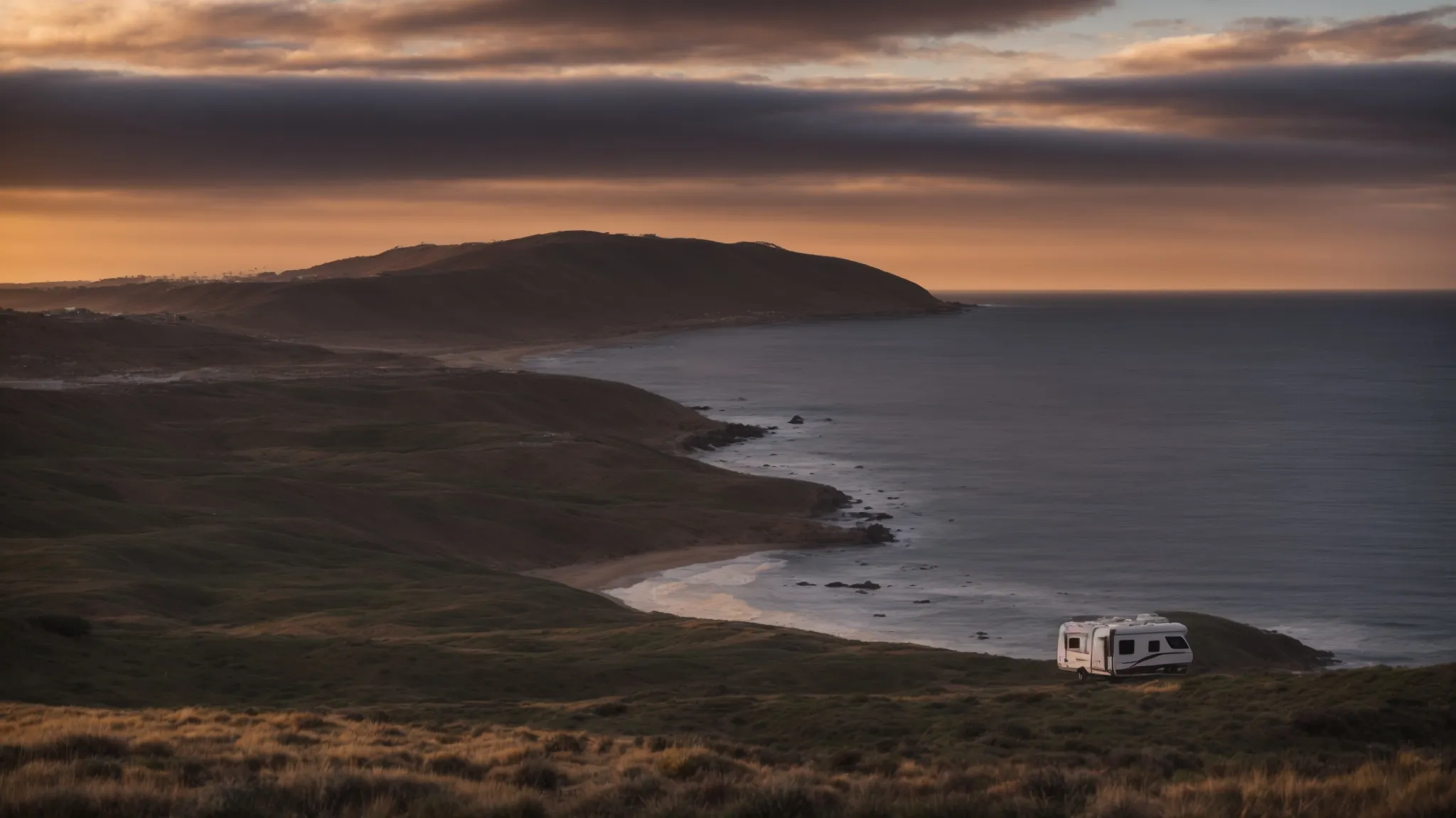 an rv parked along the picturesque san diego coastline at sunset, ready for the next adventure.