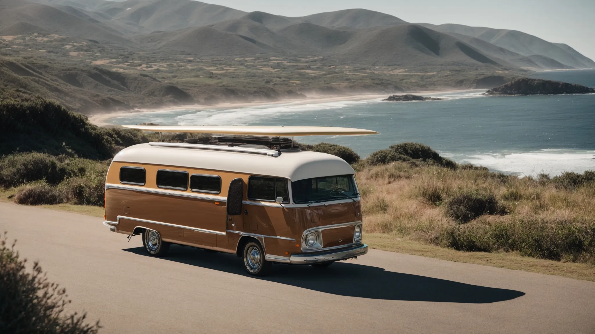 a surfboard-laden vehicle departs an rv park against a backdrop of rolling coastal hills.